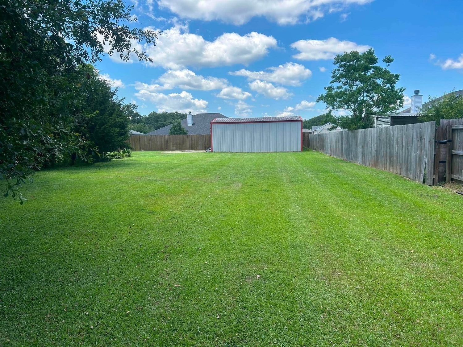 Freshly mowed backyard near a storage shed